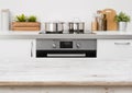 Bleached wooden texture table on defocused kitchen stove interior background
