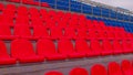 Bleachers in a sports stadium. Red and blue seats in a large street stadium. Royalty Free Stock Photo