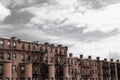 Bleak gray sky over old rowhouse, urban city dwellings