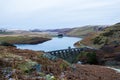 The bleak moorland and water landscape of the Elan Valley in winter. With the Victorian dam of the Craig Goch Reservoir