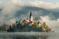 Bled island and castle in morning fog