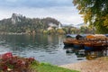 Bled lake in autumn, tradicional wooden boats Pletna. Bled castle at the background Royalty Free Stock Photo