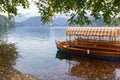 Bled lake in autumn, traditional wooden boats Pletna. Bled church at the background Royalty Free Stock Photo