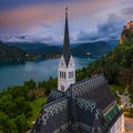 Bled, Slovenia - Aerial panoramic view of the beautiful St. Martin`s Parish Church at blue hour with Bled Castle Blejski Grad