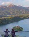 Bled/Slovenia-April 30,2018: women admiring the view of Lake Bled and Julian Alps with lake island and charming little church