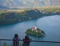 Bled/Slovenia-April 30,2018: women admiring the view of Lake Bled and Julian Alps with lake island and charming little church