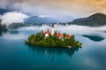 Bled, Slovenia - Beautiful foggy morning at Lake Bled Blejsko Jezero with the Pilgrimage Church of the Assumption of Maria