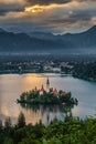Bled, Slovenia - Golden sky and clouds above Lake Bled Blejsko Jezero with the Pilgrimage Church of the Assumption of Maria