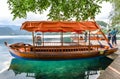 Bled, Slovenia - May 20, 2018: Beautiful Lake Bled in the Julian Alps and old wooden boat. Mountains, clear blue water, tourist bo