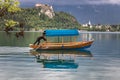 Bled, Slovenia - May 18, 2019 : men rowing a traditional slovenian wooden boat called `pletna` for transporting people,