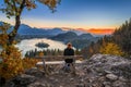 Bled, Slovenia - Red hair runner woman relaxing and enjoying the beautiful autumn view and the colorful sunrise of Lake Bled Royalty Free Stock Photo