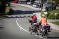 Selective blur on a senior couple riding bicycle doing bike touring in bled, in the alps, with luggage on the bicycle, Royalty Free Stock Photo