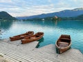 bled slovenia three wooden boats on the pier, Bled island. traditional Pletna boats on summer background Royalty Free Stock Photo