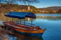 Bled, Slovenia - Traditional blue Pletna boat at Lake Bled with Pilgrimage Church of the Assumption of Maria