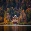 Bled, Slovenia - Typical Slovenian alpen house by the Lake Bled with boats and beautiful colorful autumn forest Royalty Free Stock Photo