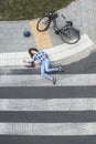 Bleeding car crash victim next to bike