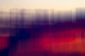A blend of blurred vertical lines creates an abstract effect with deep reds and purples flowing into lighter hues