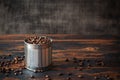 Blended coffee beans in a tin can on a rustic wooden table among scattered coffee beans, blended, vintage