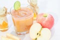 Blended fresh apple juice smoothie and honey bee and lemon.Beverage healthy the taste in glass on white wooden