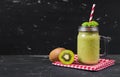 Blended fresh green smoothie with kiwi and spinach