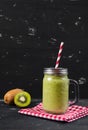 Blended fresh green smoothie with kiwi and spinach