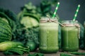 Blended green smoothie with ingredients