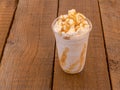 Blended Iced coffee caramel frappe in a plastic cup with whipping cream Royalty Free Stock Photo