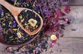 Blended tea with flower petals and dried fruit in a wooden spoon. close up Royalty Free Stock Photo