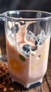 Blending a refreshing smoothie with blueberries and citrus ingredients in a kitchen environment Royalty Free Stock Photo