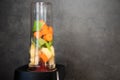 Blender with fresh vegetables. Sliced celery, apple and carrot in a blender cup for a smoothie. Healthy food. Copy space Royalty Free Stock Photo