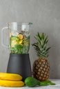 Blender with ingredients for cooking healthy detox smoothie with fresh juicy fruits, spinach, avocado, chia seeds for Royalty Free Stock Photo