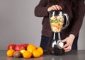 Blender, woman, fruits and gray background