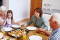 Bless the food before us and the family beside us. a multi-generational family having a meal together. Royalty Free Stock Photo