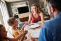 Bless the food before us and the family beside us. a young family holding hands in prayer before having a meal together Royalty Free Stock Photo