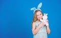 A blessed Easter. Easter bunny rabbit. Small child with cute toy. Little child in Easter rabbit style playing with toy