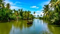 Scenic Houseboat on the backwaters during monsoon in Alleppey, Kerala, India.