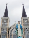 Blessed Virgin Mary, mother of Jesus, statue over cathedral with cross Royalty Free Stock Photo