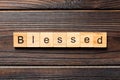 Blessed word written on wood block. Blessed text on wooden table for your desing, Top view concept Royalty Free Stock Photo
