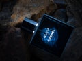 Bleu De Chanel perfume parfum on stone background