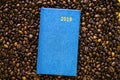 Diary lying on coffee beans.