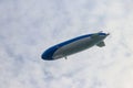 Blimp, airship or dirigible flying in sky Royalty Free Stock Photo