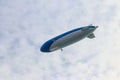 Blimp, airship or dirigible flying in sky Royalty Free Stock Photo