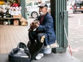 Blind busker plays guitar at Pike Place Public Market, Seattle