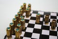 Blind and gas bullets on chessboard like black and white chess pieces Royalty Free Stock Photo