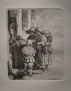 A blind hurdy-gurdy payer and his family receiving alms at the door of a house from 1648 by Rembrandt