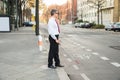 Blind man crossing road Royalty Free Stock Photo