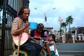Blind Man beside disabled Beggar in wheelchair at Church yard Gate Portal to seek alms
