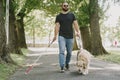 Blind man with guide dog in a summer city Royalty Free Stock Photo