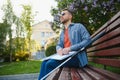 Blind man reading braille book, sitting on bench in summer park, resting Royalty Free Stock Photo