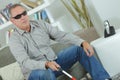 Blind man sat at home holding stick Royalty Free Stock Photo